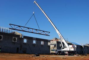A Large Crane In Front Of A Building